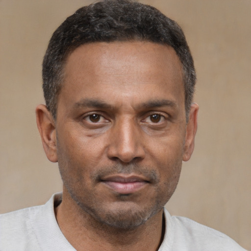 Neutral latino adult male with short  brown hair and brown eyes
