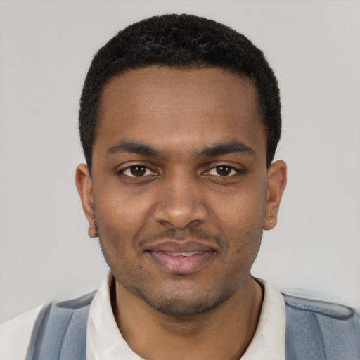 Joyful black young-adult male with short  black hair and brown eyes