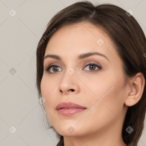 Neutral white young-adult female with long  brown hair and brown eyes