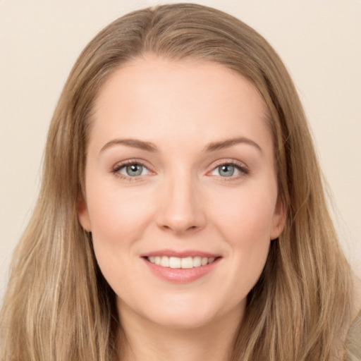 Joyful white young-adult female with long  brown hair and grey eyes