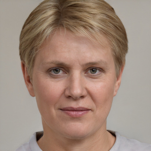 Joyful white adult female with short  brown hair and grey eyes