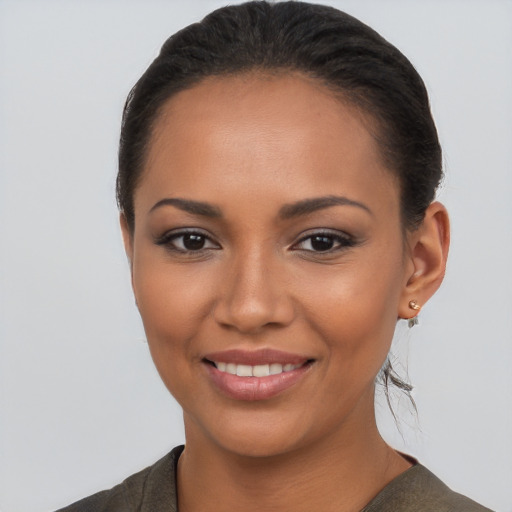 Joyful latino young-adult female with short  brown hair and brown eyes