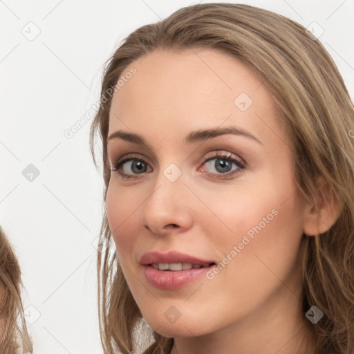 Joyful white young-adult female with long  brown hair and grey eyes