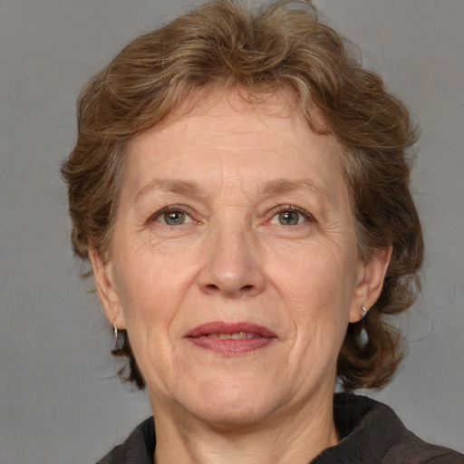 Joyful white middle-aged female with medium  brown hair and blue eyes