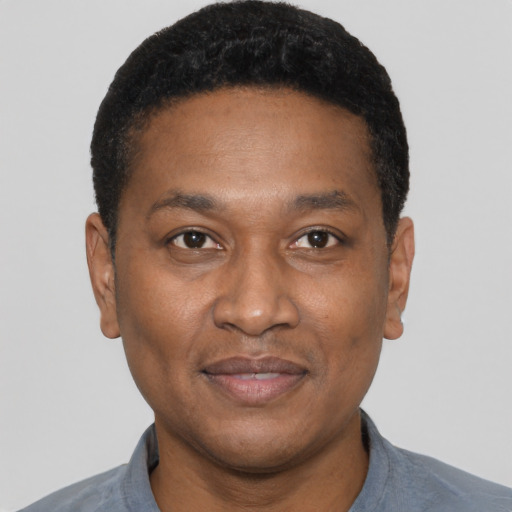 Joyful latino adult male with short  black hair and brown eyes