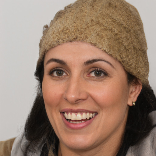 Joyful white adult female with long  brown hair and brown eyes