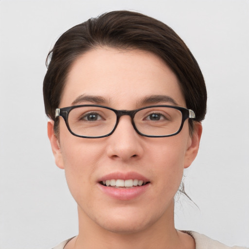 Joyful white young-adult female with short  brown hair and grey eyes