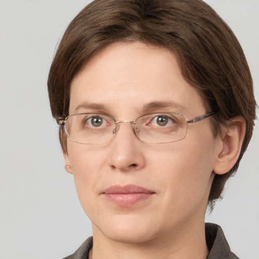 Joyful white adult female with short  brown hair and grey eyes