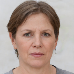 Joyful white adult female with short  brown hair and grey eyes