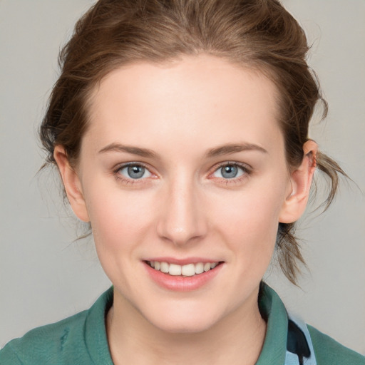 Joyful white young-adult female with medium  brown hair and blue eyes