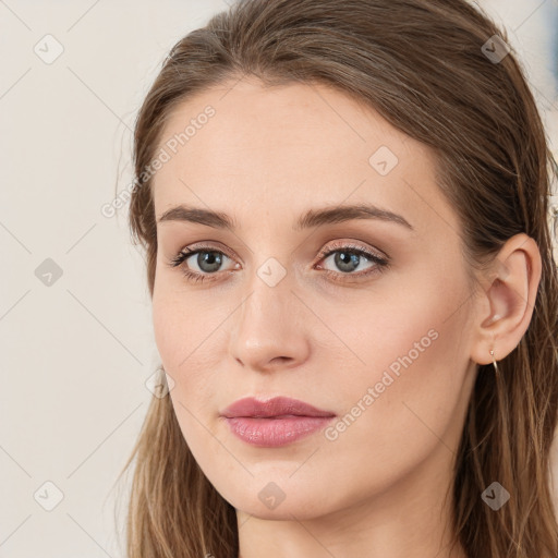 Joyful white young-adult female with long  brown hair and blue eyes