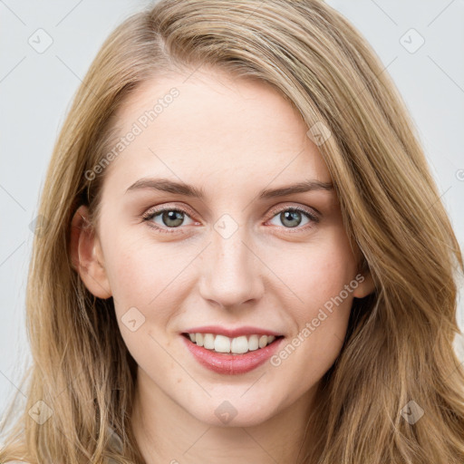 Joyful white young-adult female with long  brown hair and blue eyes