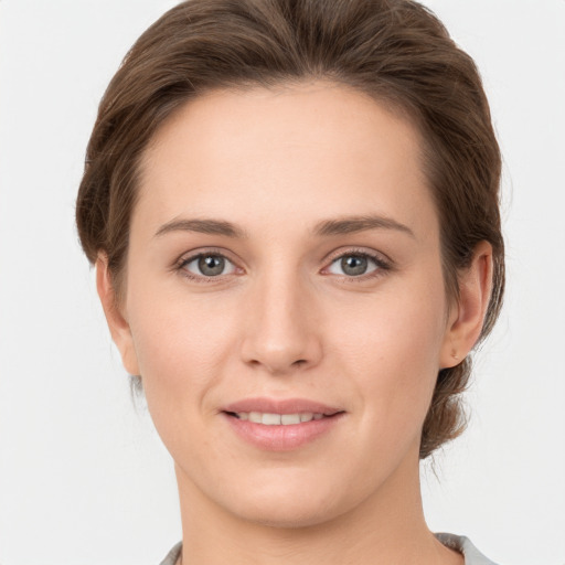 Joyful white young-adult female with short  brown hair and grey eyes