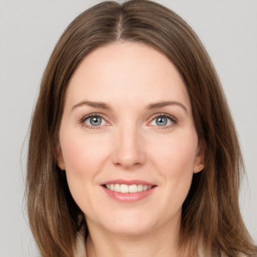 Joyful white young-adult female with medium  brown hair and grey eyes