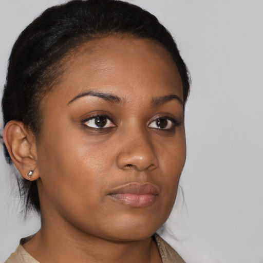 Joyful black young-adult female with medium  brown hair and brown eyes
