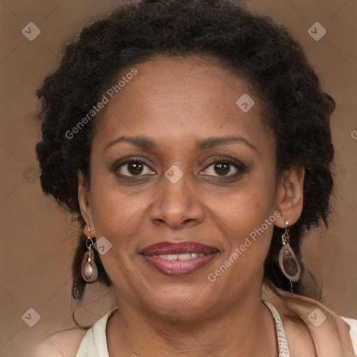 Joyful black adult female with long  brown hair and brown eyes