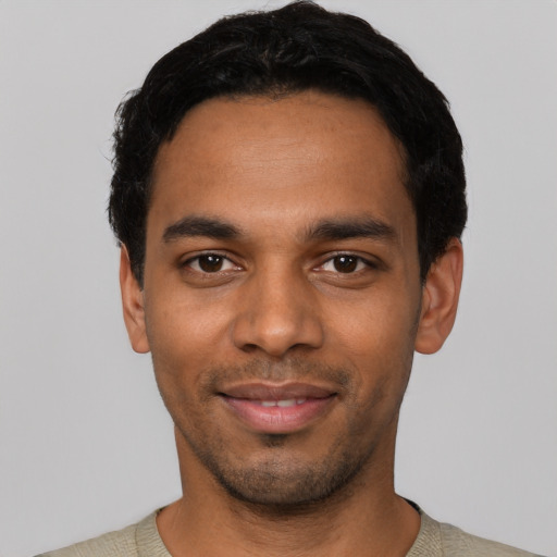 Joyful latino young-adult male with short  black hair and brown eyes
