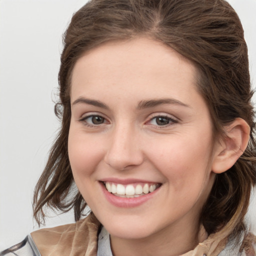 Joyful white young-adult female with medium  brown hair and grey eyes