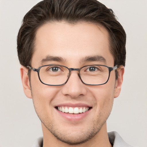 Joyful white young-adult male with short  brown hair and brown eyes