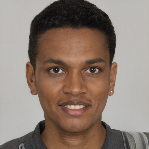 Joyful black young-adult male with short  black hair and brown eyes
