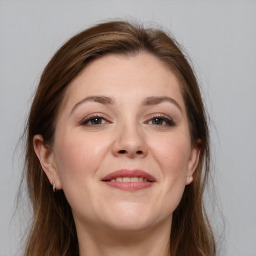 Joyful white young-adult female with long  brown hair and grey eyes