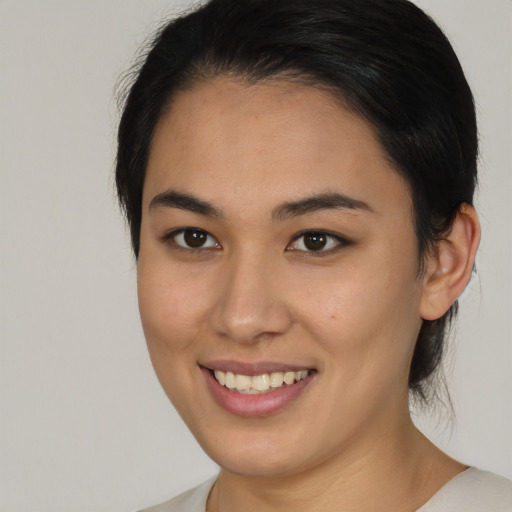 Joyful asian young-adult female with medium  brown hair and brown eyes