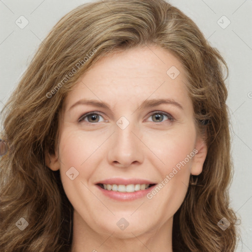 Joyful white young-adult female with long  brown hair and green eyes