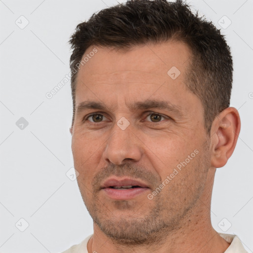 Joyful white adult male with short  brown hair and brown eyes