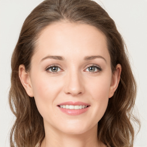 Joyful white young-adult female with long  brown hair and green eyes