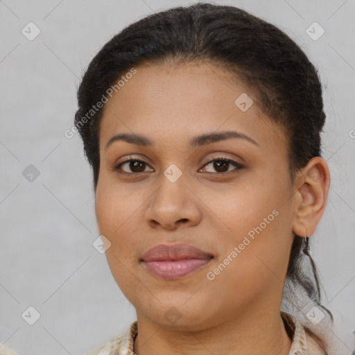 Joyful black young-adult female with short  brown hair and brown eyes