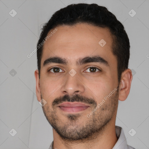 Joyful latino young-adult male with short  black hair and brown eyes