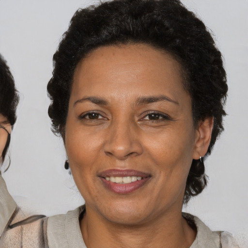 Joyful latino adult female with short  brown hair and brown eyes