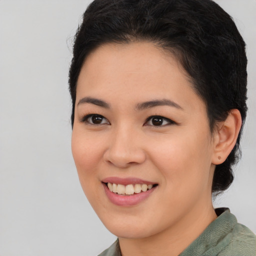 Joyful asian young-adult female with short  brown hair and brown eyes
