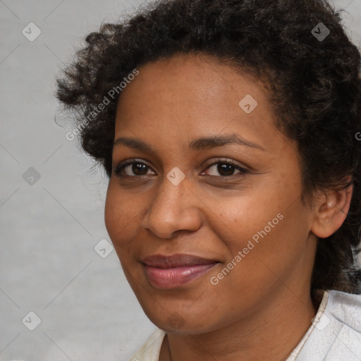 Joyful black adult female with short  brown hair and brown eyes