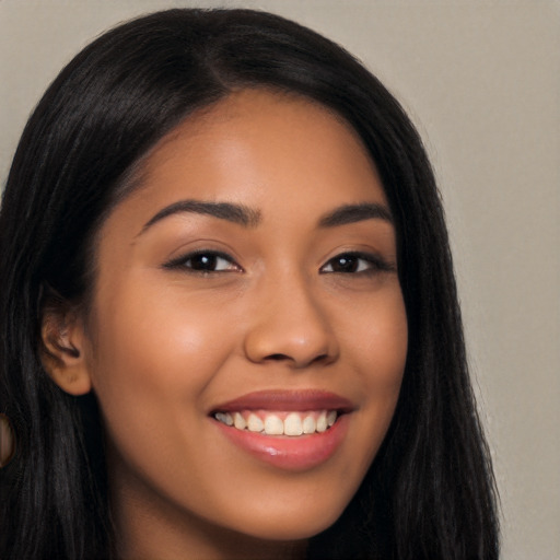 Joyful latino young-adult female with long  brown hair and brown eyes