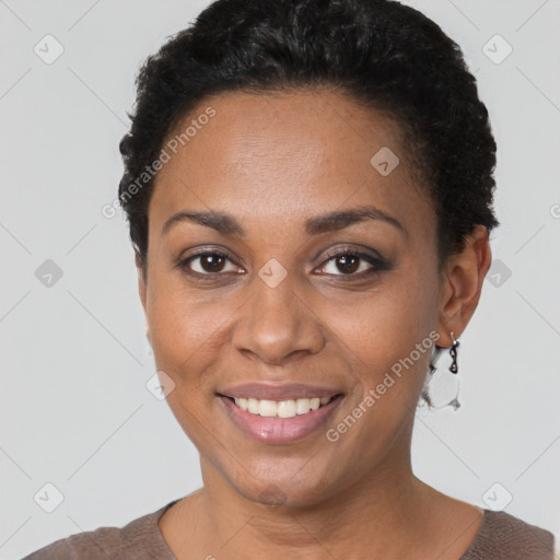 Joyful black young-adult female with short  black hair and brown eyes