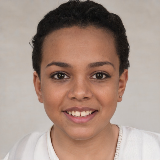 Joyful white child female with short  black hair and brown eyes