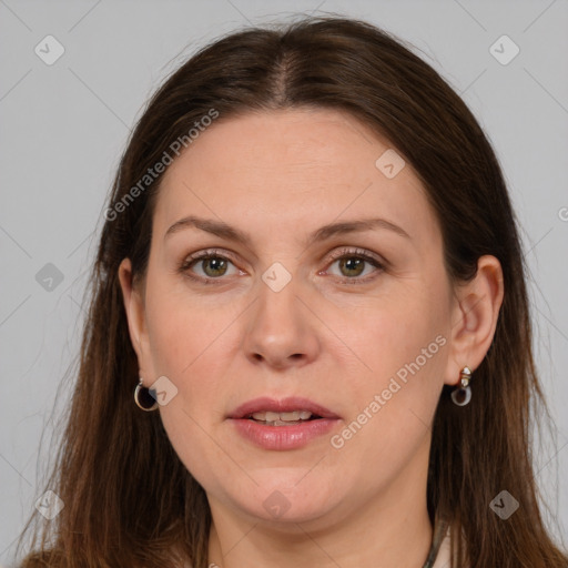 Joyful white adult female with long  brown hair and grey eyes