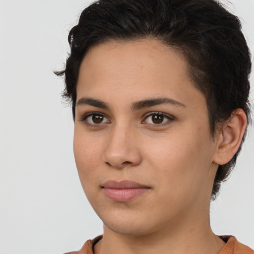 Joyful latino young-adult female with short  brown hair and brown eyes