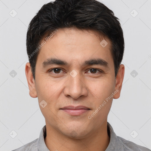 Joyful white young-adult male with short  black hair and brown eyes