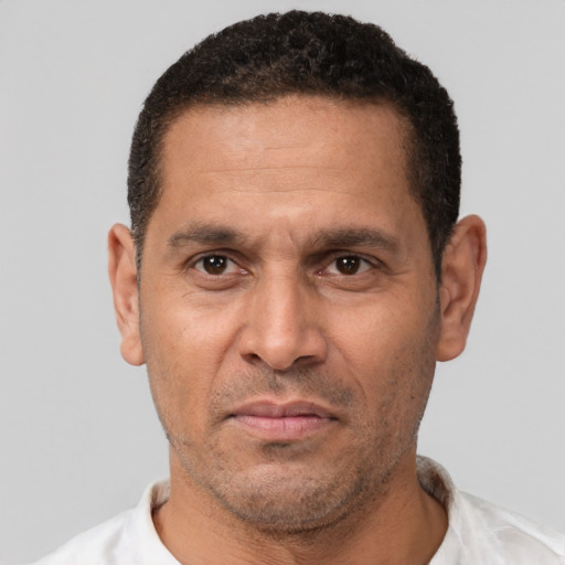 Neutral latino adult male with short  brown hair and brown eyes