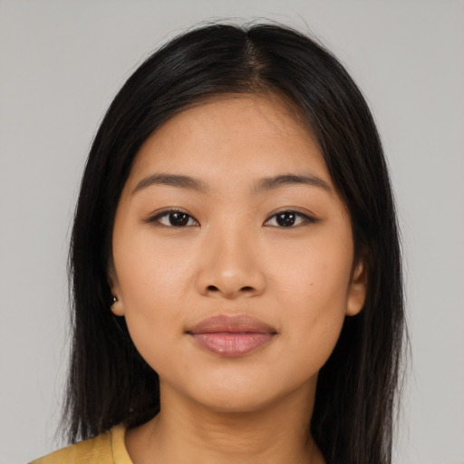 Joyful latino young-adult female with long  black hair and brown eyes