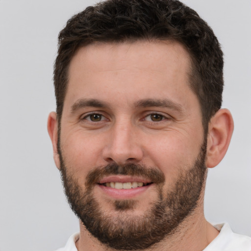 Joyful white young-adult male with short  brown hair and brown eyes