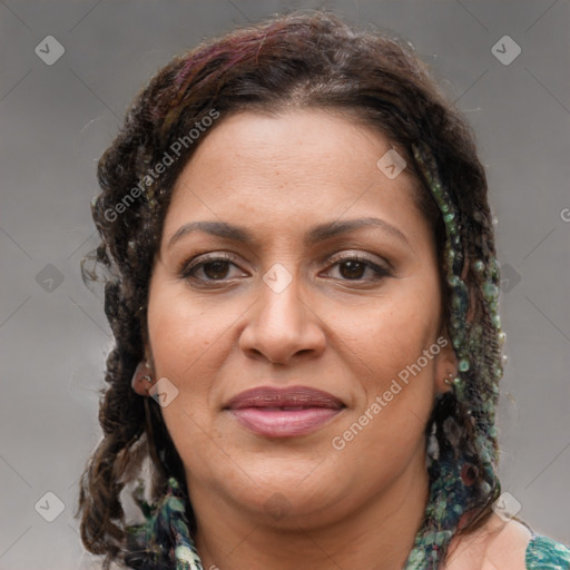 Joyful latino adult female with medium  brown hair and brown eyes