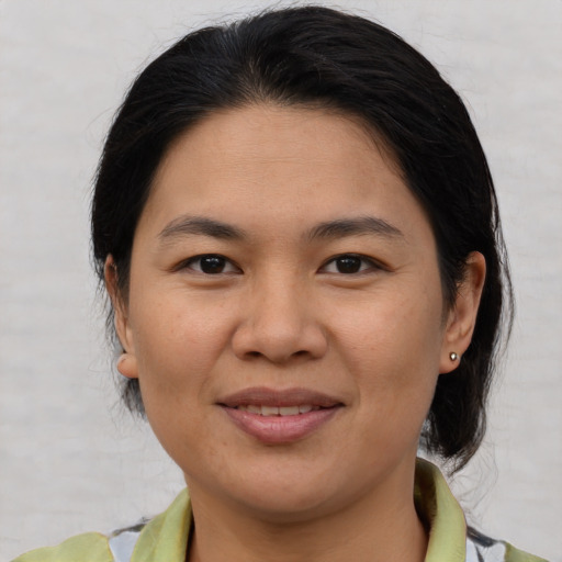 Joyful asian young-adult female with medium  brown hair and brown eyes