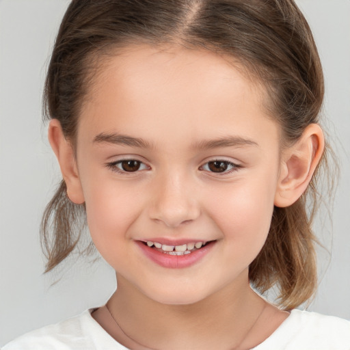 Joyful white child female with medium  brown hair and brown eyes