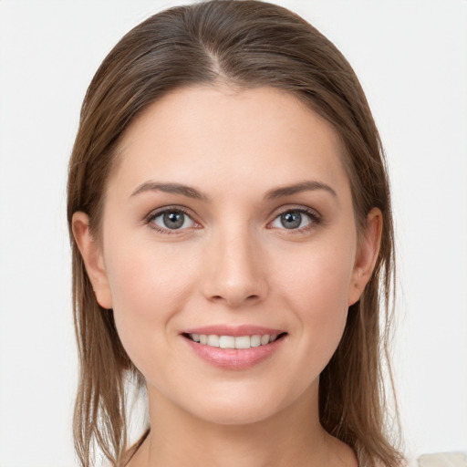 Joyful white young-adult female with long  brown hair and grey eyes