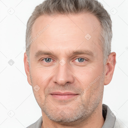 Joyful white adult male with short  brown hair and grey eyes