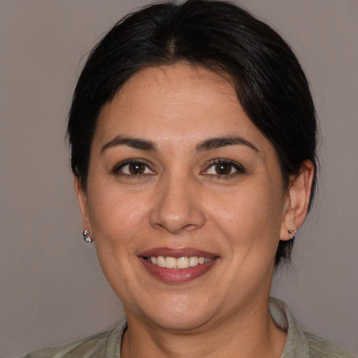 Joyful white adult female with medium  brown hair and brown eyes