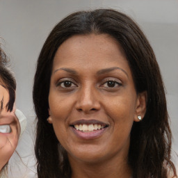 Joyful white adult female with medium  brown hair and brown eyes